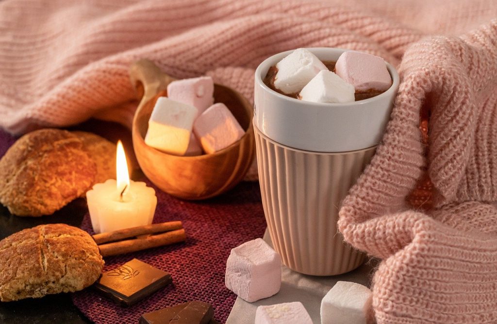 Cosy home hot chocolate and marshmallows by candlelight