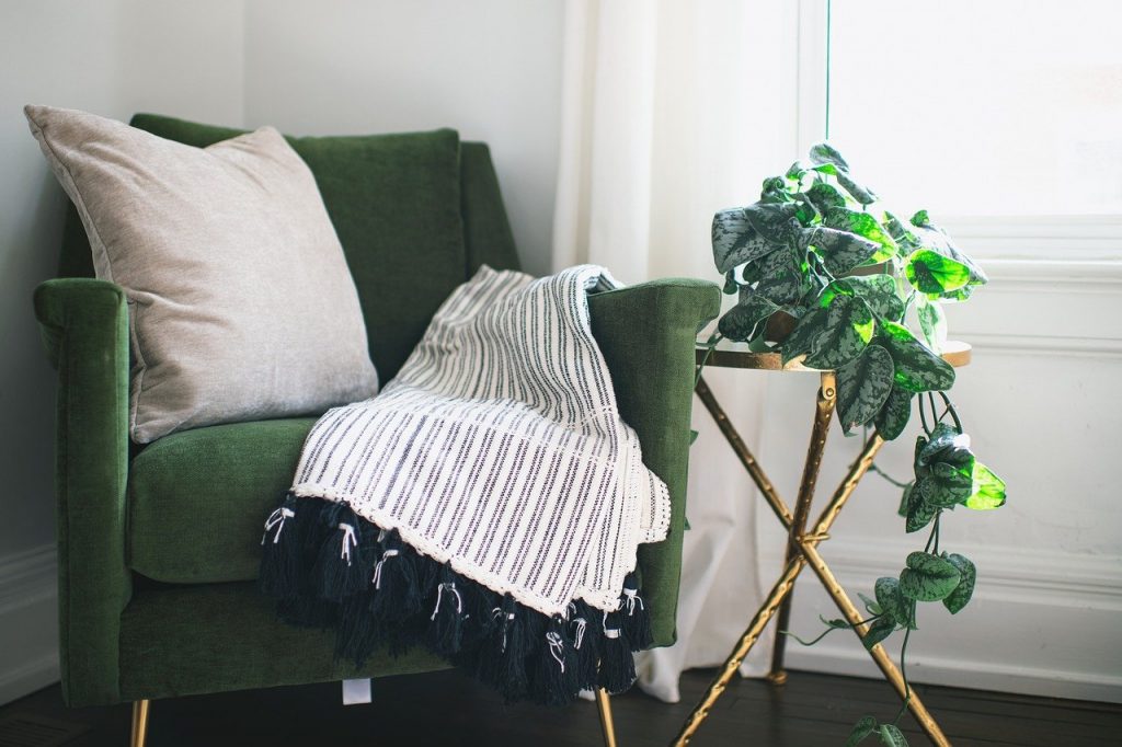 Green chair and blanket in a cosy home