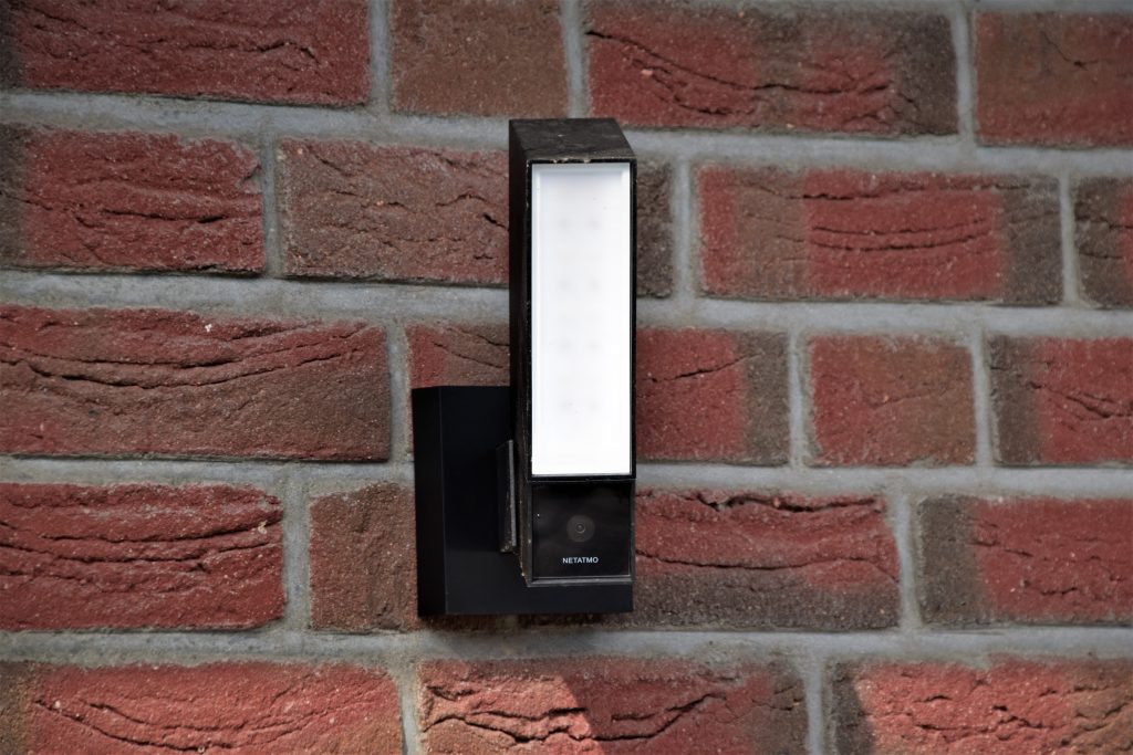 A motion detector light on the wall of a house
