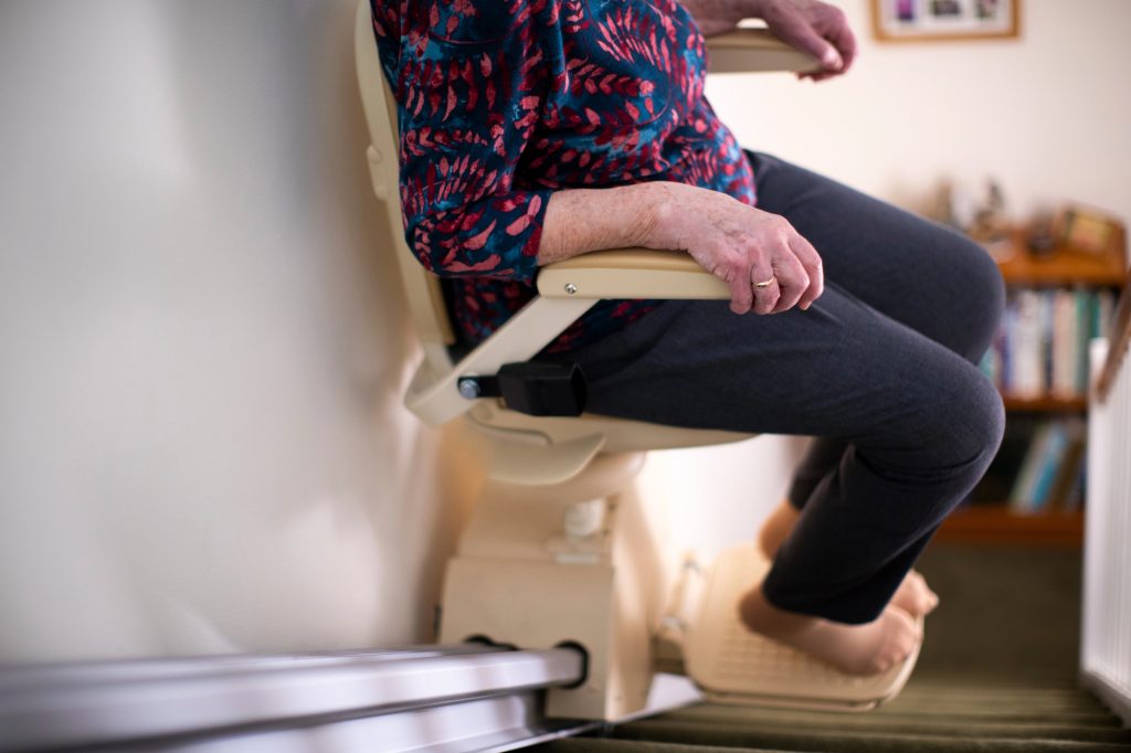 Lady on a stairlift in her home