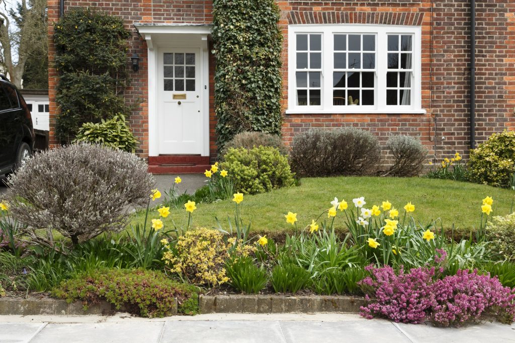 Tidy lawn and flower beds outside a house