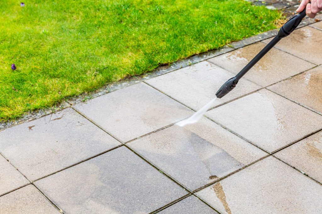 Powerwashing cleans a patio effectively